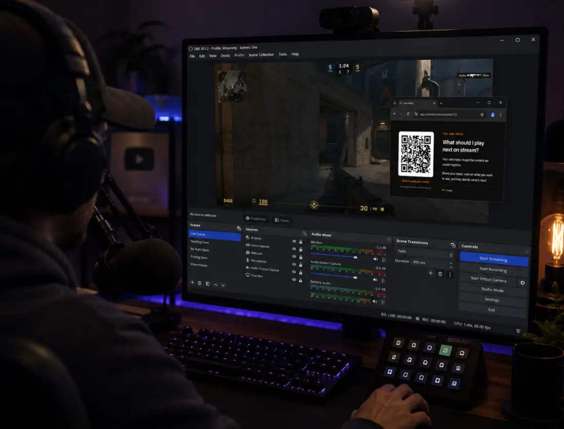 A streamer at their desk facing a broadcast layout, with a One Voicer overlay showing a QR code and the blended answer on screen.